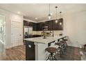 Modern kitchen with dark cabinetry, quartz countertops, and stainless steel appliances at 5135 Park Creek Avenue, North Charleston, SC 29418