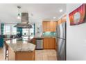 Bright kitchen featuring stainless steel appliances, granite counters, and an island at 5804 Palmetto Dr # A-401, Isle of Palms, SC 29451