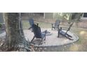 Backyard fire pit area with Adirondack chairs, perfect for outdoor gatherings at 619 Magnolia Walk Villas, Edisto Island, SC 29438