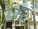 Charming two-story villa with lush landscaping and a welcoming entrance at 619 Magnolia Walk Villas, Edisto Island, SC 29438