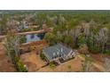 House nestled in a wooded area, near a pond and other homes at 788 Awendaw Lakes Blvd, Awendaw, SC 29429