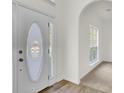 Elegant entryway with an oval glass door and hardwood floors at 7897 Sabalridge Dr, North Charleston, SC 29418