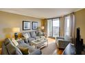 Comfortable living room with hardwood floors and access to a balcony at 8000 Palmetto Dr # 505, Isle of Palms, SC 29451
