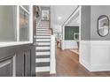 Elegant foyer with hardwood floors, staircase, and stylish decor, creating a grand entrance at 8623 Woodland Walk, North Charleston, SC 29420