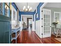 Inviting foyer with hardwood floors, blue accent walls, and decorative lighting at 120 Charleston Blvd, Isle of Palms, SC 29451
