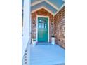 Charming front door with blue porch ceiling, cedar shake siding, and lantern sconces at 120 Charleston Blvd, Isle of Palms, SC 29451