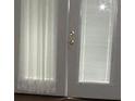 Close up on the door that features white trim and glass paneled windows at 1382 Doctor Evans Rd, Moncks Corner, SC 29461
