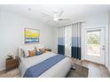 Cozy bedroom with accent wall, plush bedding, large windows, and ceiling fan at 1712 Chatelain Way, Mount Pleasant, SC 29464