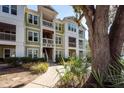 Condominium exterior with green siding, white trim, balconies, and mature landscaping at 1712 Chatelain Way, Mount Pleasant, SC 29464