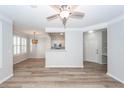 Open-concept living space with wood floors, ceiling fan, and view of the kitchen at 1712 Chatelain Way, Mount Pleasant, SC 29464
