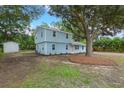 Lovely two-story home with light blue siding and a large tree providing ample shade in the front yard at 1787 Hay Rd, Johns Island, SC 29455