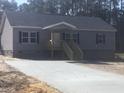 A lovely single-story home with a covered porch and a newly poured concrete driveway at 183 Waverly Rd, Walterboro, SC 29488