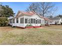 Charming home featuring a metal roof, covered porch, and well-maintained lawn at 222 E Main St, Moncks Corner, SC 29461