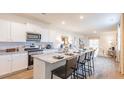Open kitchen with granite counters, stainless steel appliances, and barstool seating at 254 Watersglen Dr, Summerville, SC 29486