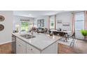 Open-concept living room with granite countertop island, wood floors, and abundant natural light at 265 Watersglen Dr, Summerville, SC 29486