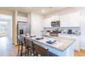 Well-equipped kitchen with granite countertops, stainless steel appliances, white cabinets, and a convenient breakfast bar at 271 Watersglen Dr, Summerville, SC 29486