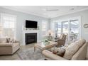 Inviting living room with a fireplace, comfortable seating, and sliding glass doors to a screened porch at 332 Clearpath Dr, Summerville, SC 29486