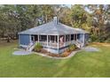 Sprawling home with a spacious yard and cozy front porch in a peaceful, wooded setting at 3348 River Landing Rd, Johns Island, SC 29455