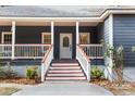 Inviting entrance with red-and-white stairs and a decorative glass front door at 3348 River Landing Rd, Johns Island, SC 29455