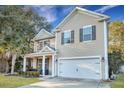 Charming two-story home with tan siding, attached garage, and inviting front porch at 3632 Locklear Ln, Mount Pleasant, SC 29466