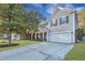 View of the house, long driveway, and lush landscaping at 3632 Locklear Ln, Mount Pleasant, SC 29466