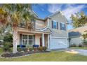 Charming two-story home with tan siding, attached garage, and inviting front porch at 3632 Locklear Ln, Mount Pleasant, SC 29466