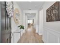 Inviting foyer with hardwood floors, a decorative mirror, and a glimpse into the living room at 376 Tupelo Lake Dr, Summerville, SC 29486