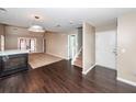 Open-concept living room with a fireplace, hardwood floors, and access to the second floor via stairs at 5215 Chicory Ln, North Charleston, SC 29420