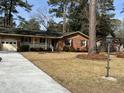 Traditional brick house with a manicured lawn and an attached two-car garage provides a comfortable and welcoming curb appeal at 715 Old Golf Rd, Summerville, SC 29483