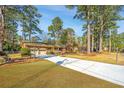Charming brick home with attached two-car garage, long driveway, and beautiful landscaping at 715 Old Golf Rd, Summerville, SC 29483