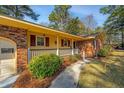 Inviting front porch of a brick home featuring charming details and manicured landscaping at 715 Old Golf Rd, Summerville, SC 29483