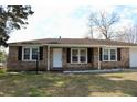 Well-kept brick home with a tidy lawn, offering classic curb appeal at 7645 Knollwood Dr, North Charleston, SC 29418
