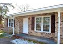 Inviting front porch with brick accents, offering a cozy entrance to the home at 7645 Knollwood Dr, North Charleston, SC 29418