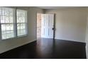 Bright living room featuring dark wood flooring, large windows and ample natural light at 7645 Knollwood Dr, North Charleston, SC 29418