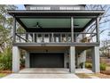 Front of the property featuring a covered porch, modern railing, and a visible two-car garage at 915 Dill Ave, Charleston, SC 29412