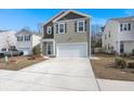Well-maintained home with a two-car garage and a large concrete driveway at 9747 Roseberry Street, Ladson, SC 29456