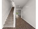 Bright foyer featuring hardwood floors and stairs leading to the upper level at 9747 Roseberry Street, Ladson, SC 29456