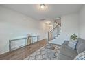 Comfortable living room featuring hardwood floors and staircase access at 106 Kirkland St, Goose Creek, SC 29445