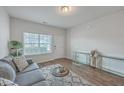 Bright living room with hardwood floors, modern furniture, and a large window at 106 Kirkland St, Goose Creek, SC 29445