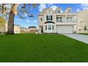 Charming two-story home with landscaped yard, a two-car garage and a lovely second story porch at 1105 Mossy Rock Dr, Summerville, SC 29485
