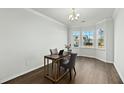 Bright office space with hardwood floors, white trim, and a large window overlooking the front yard at 1105 Mossy Rock Dr, Summerville, SC 29485