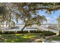 Spacious backyard with beautiful landscaping and a long dock on the water at 119 Riverland Dr, Charleston, SC 29412
