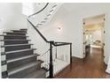 Bright foyer with a curved staircase, white railings, grey carpet and dark wood floors at 121 Jakes Ln, Mount Pleasant, SC 29464