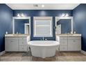 Elegant bathroom with a standalone tub, dual vanities, and stylish fixtures, creating a serene atmosphere at 121 Warbler Way, Summerville, SC 29483