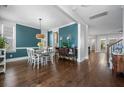 Stylish dining room with hardwood floors, a modern light fixture, and elegant decor in a bright space at 121 Warbler Way, Summerville, SC 29483