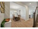 Dining area featuring wood floors, wainscoting, chandelier, and access to the kitchen at 127 Surfbird Rd, Summerville, SC 29486