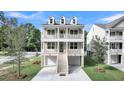 Charming elevated home featuring double porches, dormer windows, and manicured lawn at 1308 Lieben Rd, Mount Pleasant, SC 29466