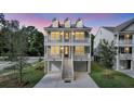 Inviting elevated home with dual balconies, dormers, and well-maintained landscaping at 1308 Lieben Rd, Mount Pleasant, SC 29466