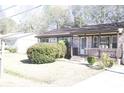 Charming brick home featuring an inviting front yard with mature landscaping at 1927 Hazelwood Dr, Charleston, SC 29407