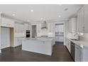 Modern kitchen with white cabinets, stainless steel appliances, and an island with a marble countertop at 2006 Riverbend Dr, Charleston, SC 29412